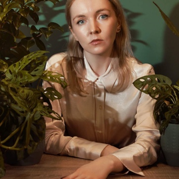 A photo of author Roisin Kiberd surrounded by plants