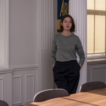 A photo of Sally Rooney standing by a window