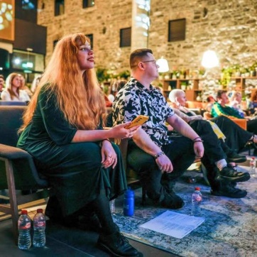 audience members watching a spoken word performance