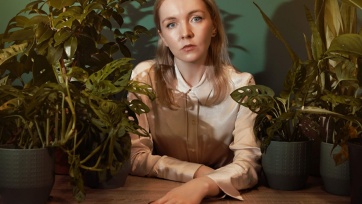 A photo of author Roisin Kiberd surrounded by plants