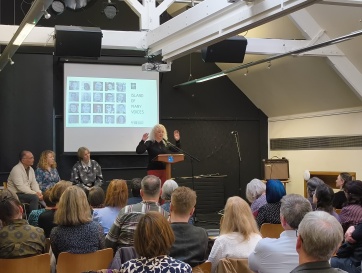 Participant Byddi Lee reading her work in front of an audience in The Linen Hall in Belfast