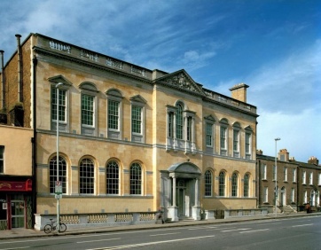 Image is an exterior photo of the Pearse Library building.