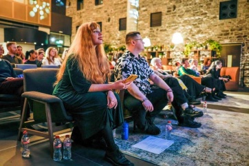 audience members watching a spoken word performance