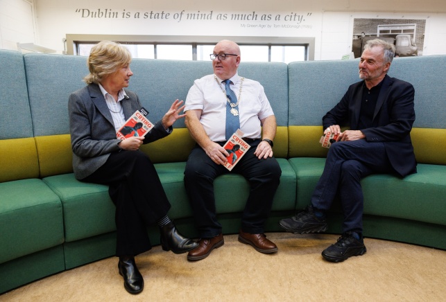 City Librarian, Mairead Owens, Councillor Vincent Jackson and Author James Butler sitting on a couch talking to one another.
